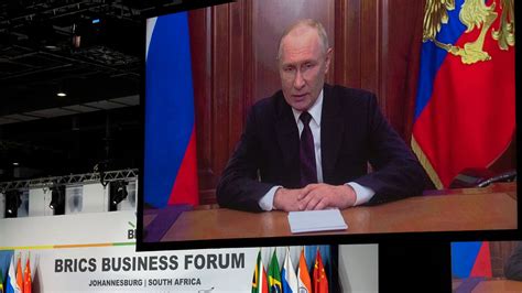 Russia’s Putin attends BRICS summit in South Africa remotely while facing war crimes warrant
