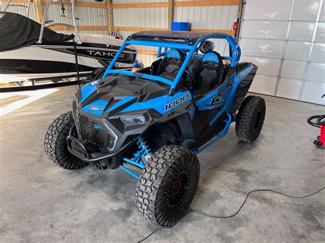 Bouncer Cage for the 2014-2023 2-Seat RZR XP1000/XP Turbo/Turbo S. Our strongest, most aggressive looking cage. This cage can be customized to be either 6" or 8" lower at the B-Pillar than factory cages. Includes: 1.75" .120 DOM Wall Tubing (not .095 Wall) Aluminum Roof Panel. Upper Windshield Bar. Double B-Pillars. Intrusion Bars. Rear X-Bracing 