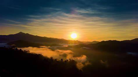 Sea of clouds covering a mountain valley at sunrise with ... - Vecteezy - raincitystudios.com