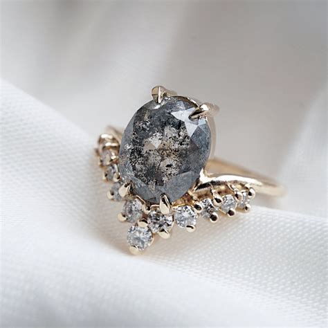 Salt and pepper engagement rings. Salt and pepper diamonds are truly unique, with their captivating inclusion patterns that resemble tiny salt and pepper specks scattered within the stone. These natural imperfections not only add character and individuality to each diamond but also create a distinctive and unconventional beauty that sets them apart from traditional clear … 