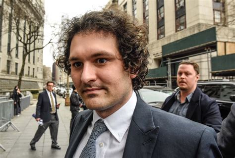 Sam Bankman-Fried, who founded and led FTX until a liquidity crunch forced the cryptocurrency exchange to declare bankruptcy, is escorted out of the Magistrate Court building after his arrest in ...