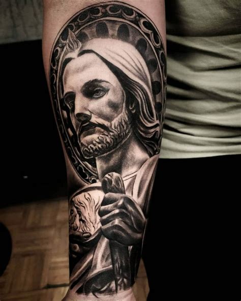 San judas tattoo. A San Judas tattoo on the arm offers great visibility and can be easily integrated into an existing sleeve or serve as the beginning of one. From the bicep to the forearm, there’s a range of options for size and complexity. This spot is also versatile enough to accommodate both black and gray or colored designs. 