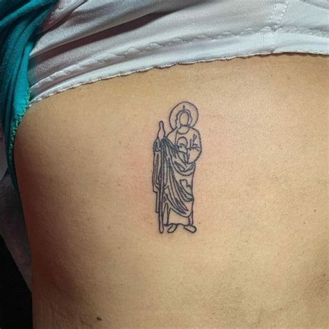 San Judas arm tattoo embody faith, courage, and hope for
