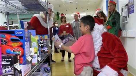 Santa and Mrs. Claus hand out presents to patients at Holtz Children’s Hospital in Miami