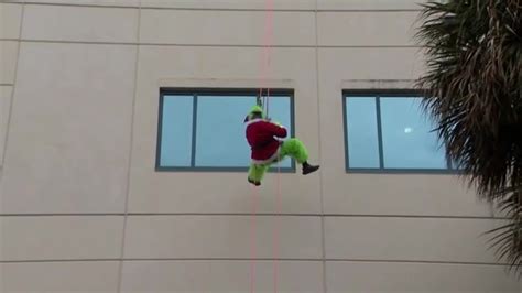 Santa and the Grinch join FLFR tactical teams rappelling down Broward Health Medical Center to spread holiday cheer
