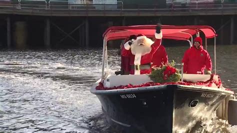 Santa trades sleigh for water taxi to hand out gifts in Seaport