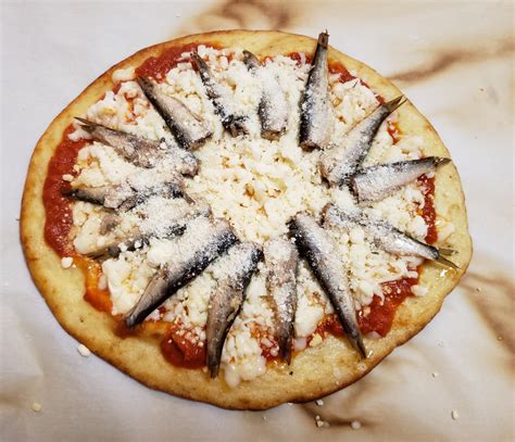 Sardine pizza. Instructions: 1. Preheat the oven to 500°F. 2. Roll out the pizza dough on a flour-dusted baking tray and brush on a thin layer of sauce. On top, place a large handful of arugula, the sliced ... 