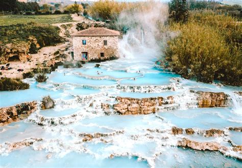  1. Cascate del Mulino. Nestled in the spa town of Saturnia, this series of waterfalls cascade sulfur-rich water from natural hot springs over rocky formations into terraced travertine pools. The water temperature hovers around 100 degrees Fahrenheit, comfortable all year round, and particularly enjoyable in winter. . 