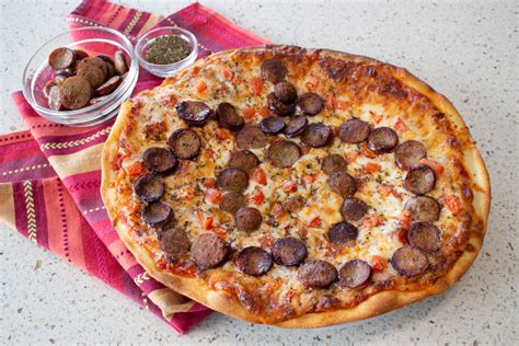 Sausage for pizza. Directions. In a small bowl, mix warm water and 1 teaspoon sugar; add yeast and whisk until dissolved. Let stand until bubbles form on surface. In a large bowl, whisk 3 cups flour, salt, remaining 1 teaspoon sugar and, if desired, dried herbs. Make a well in center; add yeast mixture and oil. Stir until smooth. 