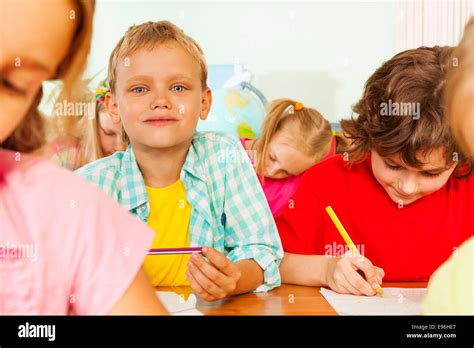 Schoolmates Sit Together In Classroom And Write Stock Image Image of