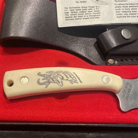 Find out at the Official Knife Collector Price Guide! Fixed-Blade Sharp Finger Knife. 7-1/4 inches long. Made in USA. "SCHRADE U.S.A. SC502" tang stamp. Stainless Steel blade etched "Schrade Scrimshaw". Whale tooth delrin handle depicts image of the head of a pronghorn. With original box, leather sheath, and paperwork.. 