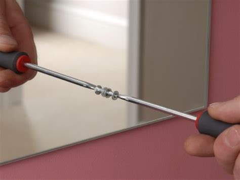 Molly bolts are a medium-weight hollow wall anchor. To use, drill a pilot hole, then tap the entire bolt—sleeve and screw—into the hole until flush against the wall. Tighten the bolt into the wall to expand the anchor. Once you’ve tightened the bolt fully, you can unscrew it a bit for space to hang the mirror.