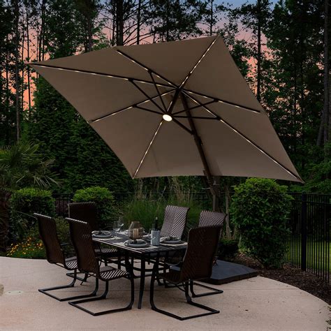 Keep your backyard protected from the sun with this Hampton Bay 11-ft. aluminum and steel Cantilever patio umbrella. You can set it up quickly with the crank lift system. Solar-powered LED lights let you see at night. For lasting use, it offers a rust-resistant steel pole and a fade-resistant polyester canopy.