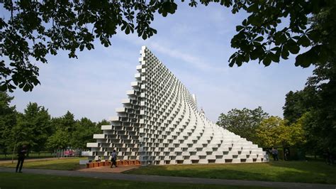 Serpentine gallery london. The structure is located outside the Serpentine Gallery in London's Kensington Gardens. It is made up of translucent fibreglass frames, stacked on top of each other in a typical brickwork pattern. 