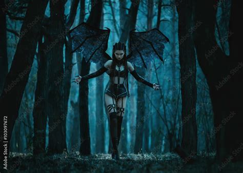 Black long silky hair, big blue eyes, bat like wings, black netted ribcage, normal human breasts, black arms and hands and horse like feet and a long skirt green in colour. . Sexualsuccubus