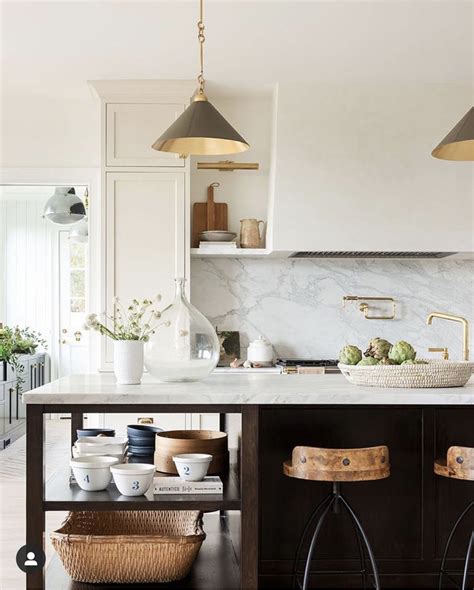 Studio McGee. Eat-in kitchen - transitional l-shaped light wood floor and beige floor eat-in kitchen idea in Salt Lake City with white cabinets, marble countertops, white backsplash, paneled appliances, an island, a double-bowl sink, shaker cabinets and white countertops. Sponsored. CliqStudios. 10% off Select Cabinets & Hardware.. 