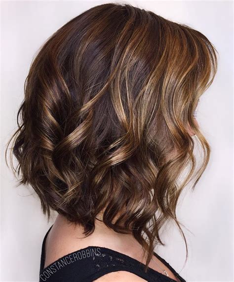 Short brown hair with light brown highlights. Caramel Ombre Highlights. This is another take on the Tiger’s Eye trend, but with a slightly more ombre approach. The ends are lightened to a golden caramel color, and lowlights are created with a dark, reddish-brown. The highlights don’t go all the way up to the roots of the hair, creating the classic ombre look. 