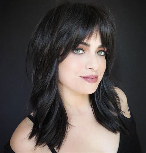 Long and Straight Bangs With Wavy Lob. Ciara's bangs are proof that fringe can go past the eyebrows and still look chic. Here, her straight bangs are styled with curled hair that hits above the shoulders. Use a medium-barrelled curling …. 