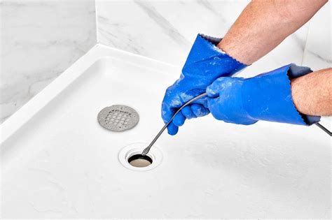 Shower drain snake. For shower drains, use a rubber drain cover or a wet washcloth to block the drain. Fill the tub or shower basin with hot water. Let it sit for 10 minutes before pulling the plug; the emptying water should push the vinegar-soda-softened clog out of the pipe. Flush with boiling water. 