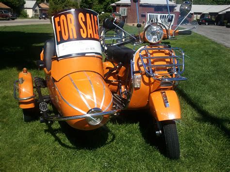 Sidecar for a scooter. Watsonian Squire USA serves as the sole distrubution center in North and South America for Watsonian Sidecars imported from the UK. Watsonian Sidecars established in 1912 is the worlds oldest and most prominent sidecar company, with healthy worldwide sales. 