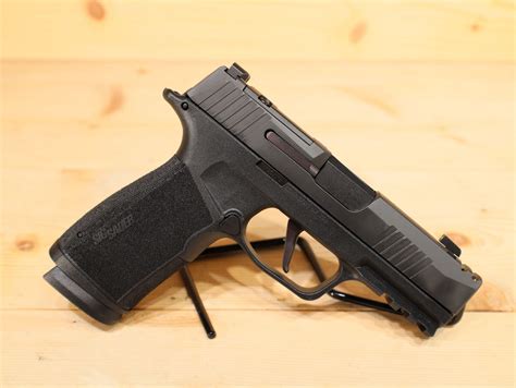 The P365 X-Macro is definitely a piece worth checking out to consider adding to the rotation. Includes two 17-round flush fit magazines. Compensated slide for recoil reduction. Macro-compact grip module with S, M, and L backstraps. 1913 accessory rail fits more sights and lasers. Flat trigger.. 