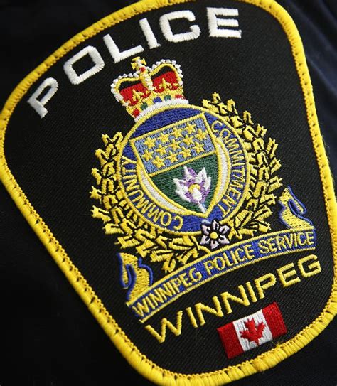 Signs calling for police to search landfills taped to Winnipeg police headquarters