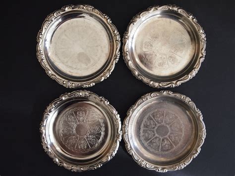 Set of five very elegant and very vintage silver plated EP on steel coasters. These beautiful silver coasters are made in Italy and measure approximately 4 ¼ diameter. These silver coasters display a rope and flower cameo pattern on the inside and a very ornate scroll pattern ruffled edge. The back . 