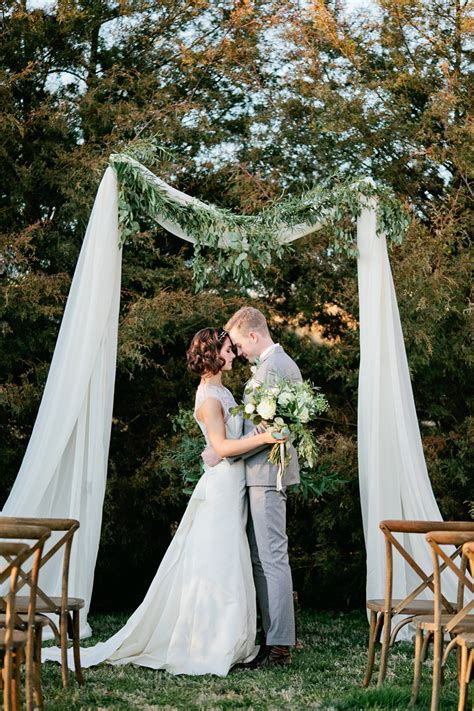 Simple wedding. 3. Two Doors Connected By A Pole. In considering DIY wedding ideas, you’re opening yourself up to infinite possibilities when it comes to crafting your unique arch. Consider a fun backdrop display like this one which frames a unique scene amid two doors painted to appear aged. 4. Tree Branches With Greenery. 