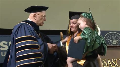Single mom from Brockton walks across graduation stage with 2-year-old in her arms