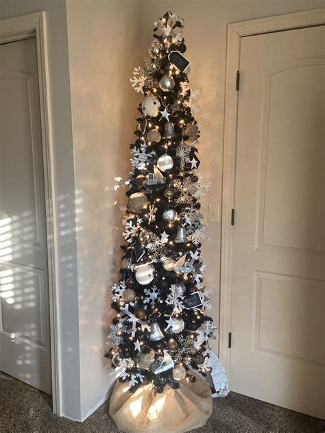 Skinny black christmas tree. flocked black tree I knew we were going to go all in. Most of the ornaments are from At Home and Holiday Warehouse which is a local store in Dallas, Texas. I ... 