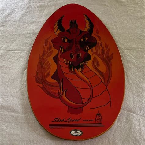 Vintage 2001 Slick Lizard Skim Pro Skim X-treme skim board. Flame design. Pre owned but in good condition. Does have some cosmetic issues from normal use. Some crackimg on the top, scratches and paint chiping on the back. See last few pictures for the issues. See pictures for overall condition.. 