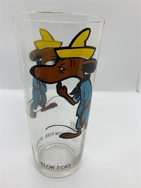 Slow poke rodriguez glass. This vintage 1973 collector glass features the lovable Slow Poke Rodriguez character from Pepsi's advertising campaign. The colorful multi-color design and Pepsi branding make this glass a perfect addition to any soda or advertising collection. Crafted from high-quality glass, this original and authentic piece is in great condition for its age. 