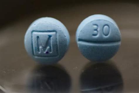 Small blue pill m. (L) is a small, round, pale blue pill, with the imprint of a capital M inside a square shape to mimic an authentic M30 tablet. (R) is burnt tin foil is often used to facilitate the inhalation of ... 