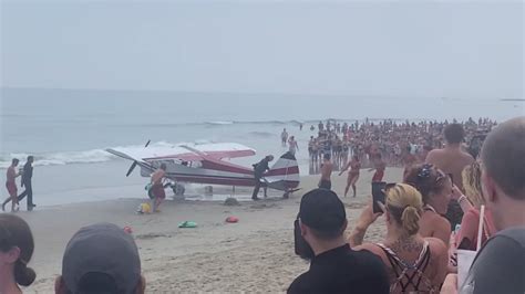 Small plane towing banner lands in ocean off crowded New Hampshire beach; pilot unhurt