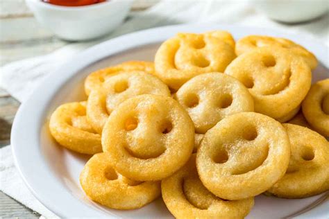 Smiley fry. Now rest the smileys in refrigerator again for 30 mins. In a pan, heat oil for deep frying the potato smiley. Once hot, keep in medium flame and drop the smileys carefully. Fry till golden and crispy. Drain the smileys on paper towel. Serve hot with ketchup. Potato smiles recipe 