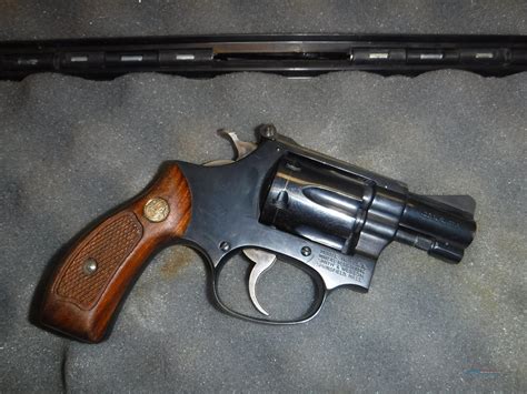 Welcome to the forum! Your gun appears to be a 32 Smith & Wesson Hand Ejector, 3rd model made between 1911 and 1942; serial number range, 263001-536684. After 1958 that model became known as the S&W Model 30.The finish is called as blue or blued and the grips look to be genuine mother of pearl (MOP)...very fragile and chip easily..