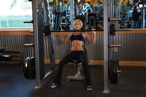 Smith machine overhead press. Learn how to perform the Smith machine overhead press, a beginner-friendly shoulder exercise that helps increase strength and muscle growth. Follow the instructions, watch the video and avoid common mistakes. 