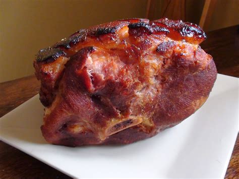 Smoked picnic shoulder. Place the ham on a rack in a baking pan, fat-side up. Cover loosely with aluminum foil. Bake at 325 F for about 30 minutes a pound, or to 140 F on the meat thermometer. Place a sieve or colander over a bowl and drain the pineapple. Measure 1/4 cup of the pineapple juice into a saucepan. 