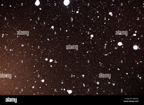 Snow falling night sky Stock Photos and Images - Alamy