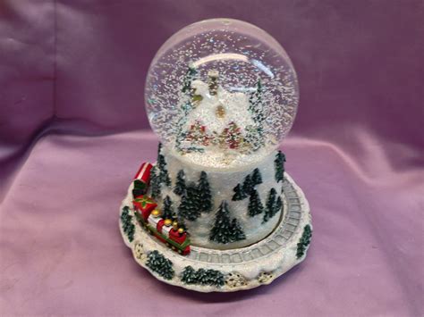 Snow globe repair. In this video we repair an cool and unusual snow globe. Santa is in the globe at the engineers spot. The globe uses batteries to make a train sound and light... 