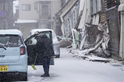 Snow hinders rescues and aid deliveries to isolated communities after Japan quakes kill 128 people