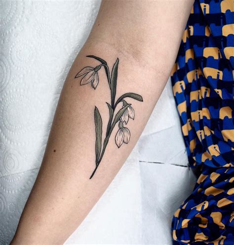 These snowdrop flower tattoo ideas symbolize pu