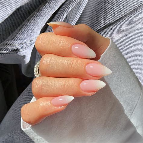 Nude Nails With White, Black or Coloured Tips. The French manicure – a nude nail base with a white polish applied to the tip is one of the most well-loved, go-to nude nail looks. Go elegant in white, or add some fun with a black, coloured or shimmer polished tips to change up this beloved nude nail trend. @mariananabruzzinails.. 