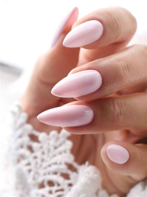 These jelly nude nails have the prettiest light pink foundations. Glistening white and silver sprinkles help the muted bases to shimmer in the light. The ballet soft pastel nude nail designs idea looks flattering against just about every skin tone. Almond-shaped extensions serve as a subtle yet sexy foundation for this timeless nail design.. 