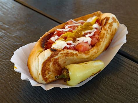 Sonoran dog. Directions ... Coil one strip of bacon around each hot dog from end to end. Place toothpicks though both the bacon and dogs near each end to hold the bacon in ... 