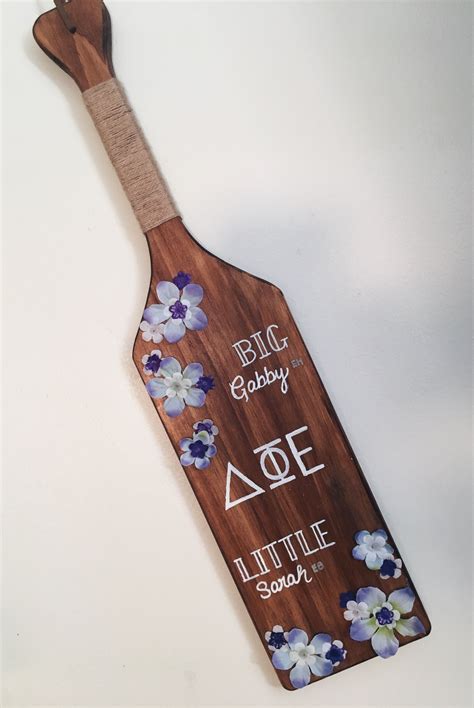 Measuring 22" x 3.5" x 3/4", these paddles feature laser-engraved walnut, and each one includes the fraternity's crest and up to a 10-word personalization engraved on the front. On the back, the frat paddle features the chapter's Greek letters in Old English style print. Please note, we cannot print college names on fraternity paddles. . 