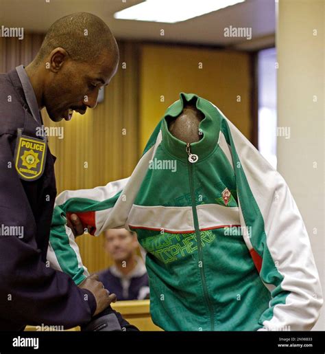 South African Xolile Mngeni, shields his face with his jacket , at ...