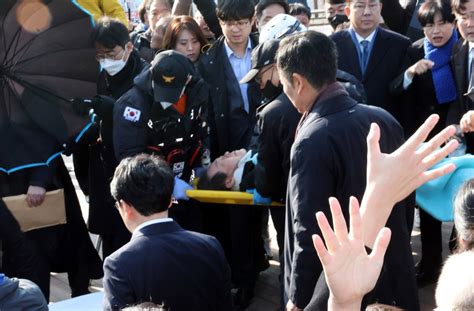 South Korean opposition leader is stabbed in the neck. Police say attacker approached for autograph