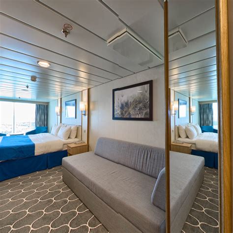 Spacious panoramic ocean view. Spacious Panoramic Ocean View staterooms feature a floor-to-ceiling wrap around panoramic window. They have two twin beds that convert to a Royal King, and a double sofa bed for quad staterooms. There is a vanity with sitting area, and private bathroom with shower. Deck: Deck 12: 