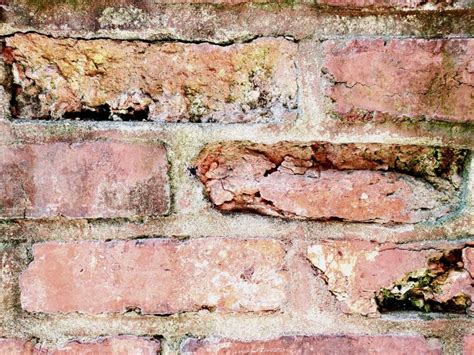 Spalling brick. Brick spalling is damage to brick masonry that is the result of improper pointing or moisture trapped into mortar joints. Spalling is the cracking of the outer face of a masonry surface. The picture below shows an example of a brick knee wall where the specific brick units have spalled. The faces of those brick units have cracked off and fallen ... 